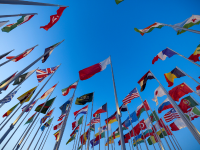 Blue sky background with global flags
